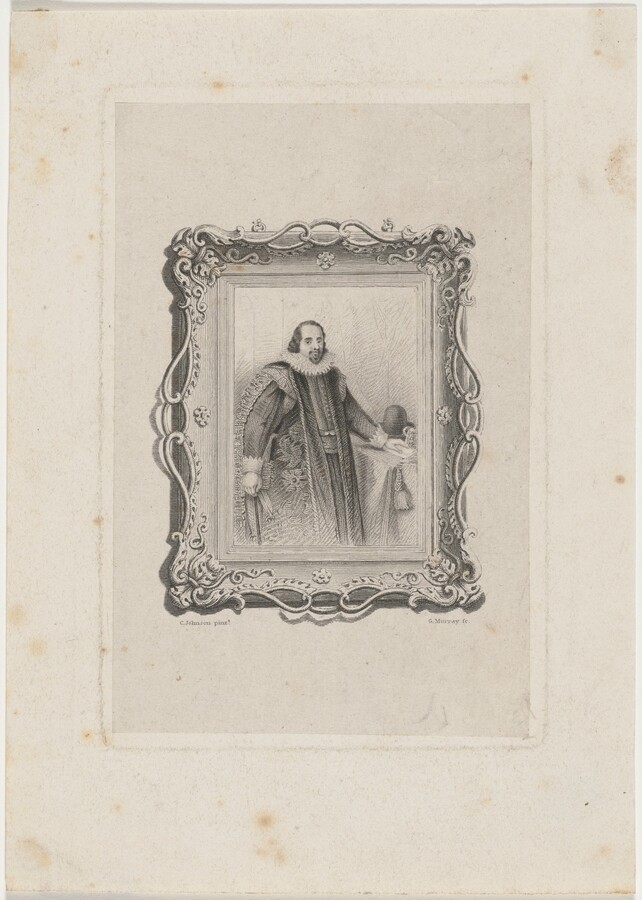 The image shows a full-length portrait of a man within an ornate decorative border. The man is in a three-quarter pose, facing slightly right with one hand on a table. He has a mustache and goatee, medium-length curled hair, and wears a detailed robe with a fur collar and patterns. He also wears a ruffled collar and holds gloves in his right hand, with a hat on the table next to him. The background has a simple wall pattern, and the portrait is enclosed within a highly detailed floral-patterned frame with swirling embellishments. The engraving appears aged.