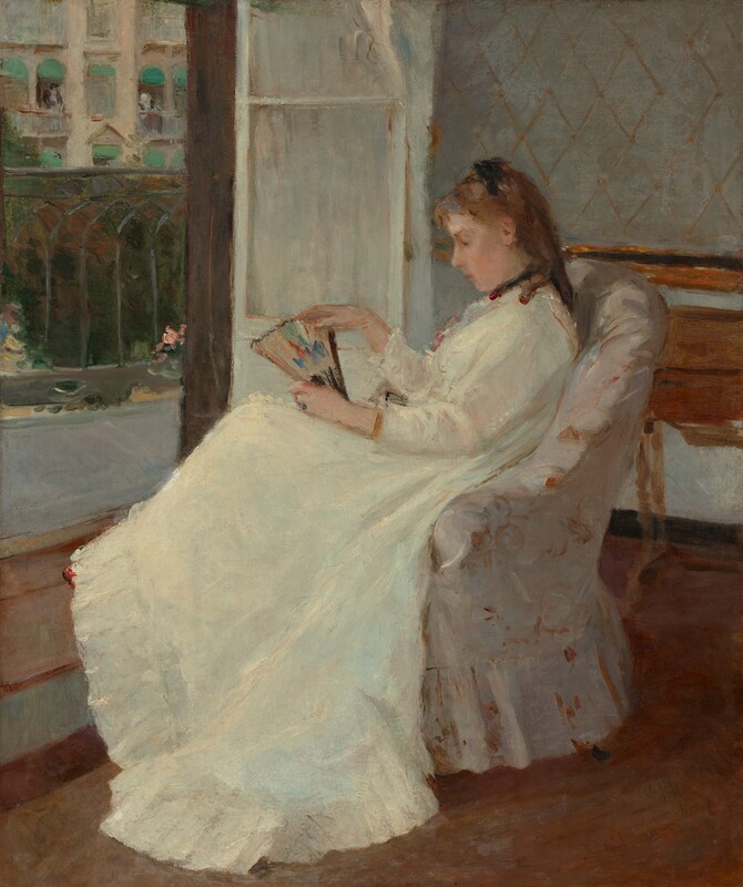 A young woman with pale peach skin and light brown hair sits in profile facing our left in an upholstered chair in this vertical painting. The chair and woman take up most of the composition so seems close to us. She wears a long-sleeved white dress that sweeps to the floor, with black ribbons around her neck and atop her shoulder-length ringlets. The dress has small ruffles at her throat and a deep flounce at the bottom. She gazes down at the partially open fan she holds on her lap. The fan is touched with spots of pumpkin orange, plum purple, and royal blue on a beige background. Loose, swirling brushstrokes in golden tan and bright white against an ivory background suggest that the chair is upholstered with a floral-patterned fabric. A wooden desk or table is pushed against the wall behind the woman to our right and to our left, a white door, covered by a white curtain, opens onto a balcony with a wrought iron railing. Across the street, a couple of people lean out of open windows covered by turquoise-blue awnings on a cream-colored building.