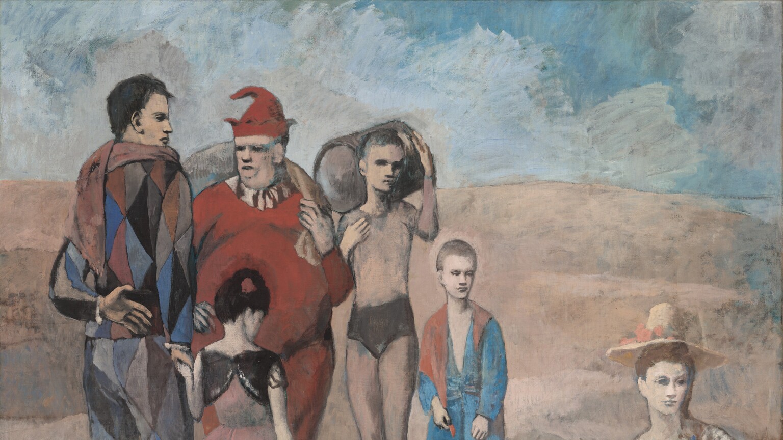 A group of three men, two children, and one woman gather in an empty, dusky rose-pink landscape under a blue, cloudy sky in this nearly square painting. Most of the people have muted, peachy skin, and the woman and the youngest boy have cream-white skin. The woman sits on the ground to our right, apart from the rest of the men and children. She wears a coral-red skirt, a beige shawl, and straw hat, and she looks into the distance to our right. The others stand in a loose semi-circle on the left half of the composition. A man wearing a multicolored, diamond-patterned costume stands with his back to us to the left. He looks to our right in profile and holds the hand of a little girl who also stands with her back to us. She wears a pink dress and white stockings, and her right hand rests on the tall handle of a white basket. A portly man wearing a scarlet-red jester’s costume and pointed hat stands opposite this pair, facing us to our right. Next to him to our right a young man wears a tan-colored leotard with a black bottom. He holds a barrel over his right shoulder and looks over to our right. The sixth person is the youngest boy, who wears a baggy blue and red outfit, and he looks toward the woman. The eyes of all the figures are deeply shadowed.
