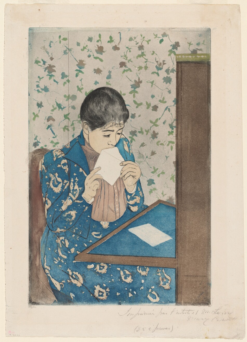 We look slightly down onto a young woman sitting at a writing desk as she licks an envelope in this vertical, color print. A table folds down or extends from a tall secretary desk to our right. The blotter on the table and the woman’s long dress are both cobalt blue. The dress has a vaguely floral pattern in white, and the jacket is open to reveal a vertically pleated, beige-pink shirt beneath. The woman’s skin is faintly tinted peach. Her black hair is pulled back over dark brows and a delicate nose. She holds the open flap of the envelope to her mouth with both hands. A piece of white paper lies on the desktop in front of her. She sits in a brown chair, and the wallpaper of the room is patterned with green and muted pink flowers against a white background. The sheet is inscribed with graphite across the right half of the bottom margin, “Imprimée par l’artiste et M. Leroy Mary Cassatt (25 épreuves)."