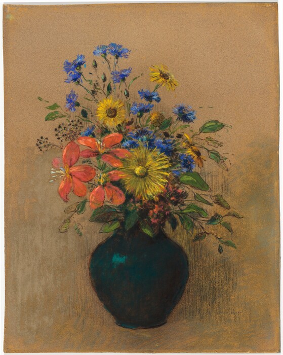 A bouquet of coral orange, bright yellow, and periwinkle blue flowers and greenery are arranged in a teal-green vase in this pastel drawn on brown paper. The orange flowers have long, curved petals. The yellow flowers have wide blooms with spiky petals, and the blue blossoms are smaller with wispy petals. The vase has a narrow opening and wide shoulders. The background is mostly the tan of the paper with some light-handed, black shading to the right. The artist signed the drawing in the lower right corner, “Odile Redon.”