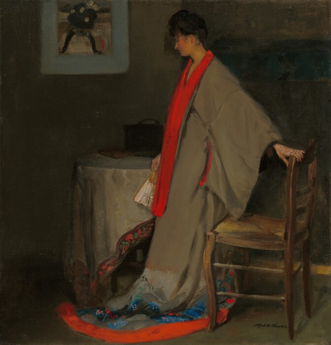 A pale-skinned young woman wearing a kimono stands facing our left in a dim interior in this vertical painting. Her black hair is upswept, and her head tilts slightly down with eyes closed. The seat of a wooden, ladderback chair rests against the back of her knees. With her left hand, closer to us, she reaches back to grasp the top rail chair behind her. She holds a folded white and brown fan in her other hand, by her side. Her voluminous robe is fawn brown and trimmed with brilliant scarlet red down the collar and around the hem. The kimono has wide, long brown sleeves that come down past her hips. The red collar extends nearly to her knees, and another slash of red lines the deep sleeve on her extended arm. The robe pools on the floor at her feet. Above the red band along the bottom hem, the robe is painted loosely in patches and dabs of black, cobalt blue, turquoise, ruby red, and pale pink. Light from the upper right gives her peachy skin a golden tinge and highlights the furniture near her, while casting the rest of the room in shadow. She stands in front of a round table draped with a fabric mottled in earth brown and gray, and bordered with a dark brown band filled with smudges of orange and green. A book and a black carrying case or bag are barely visible on the table's shadowy surface. An image framed in light blue hangs on the olive-green wall over the table. The wall to our right, behind the woman, is mostly forest green. The artist signed the lower right in black paint, “Alfred H. Maurer.”