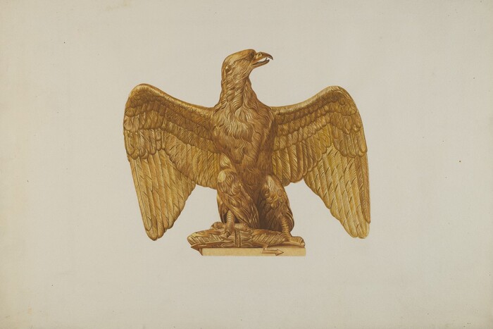 The image shows a wooden eagle with spread wings and its head turned to the side. The eagle is carved in shades of golden brown and placed on a cream background. The wings extend laterally and the body rests on a pedestal, making the eagle the main focal point.