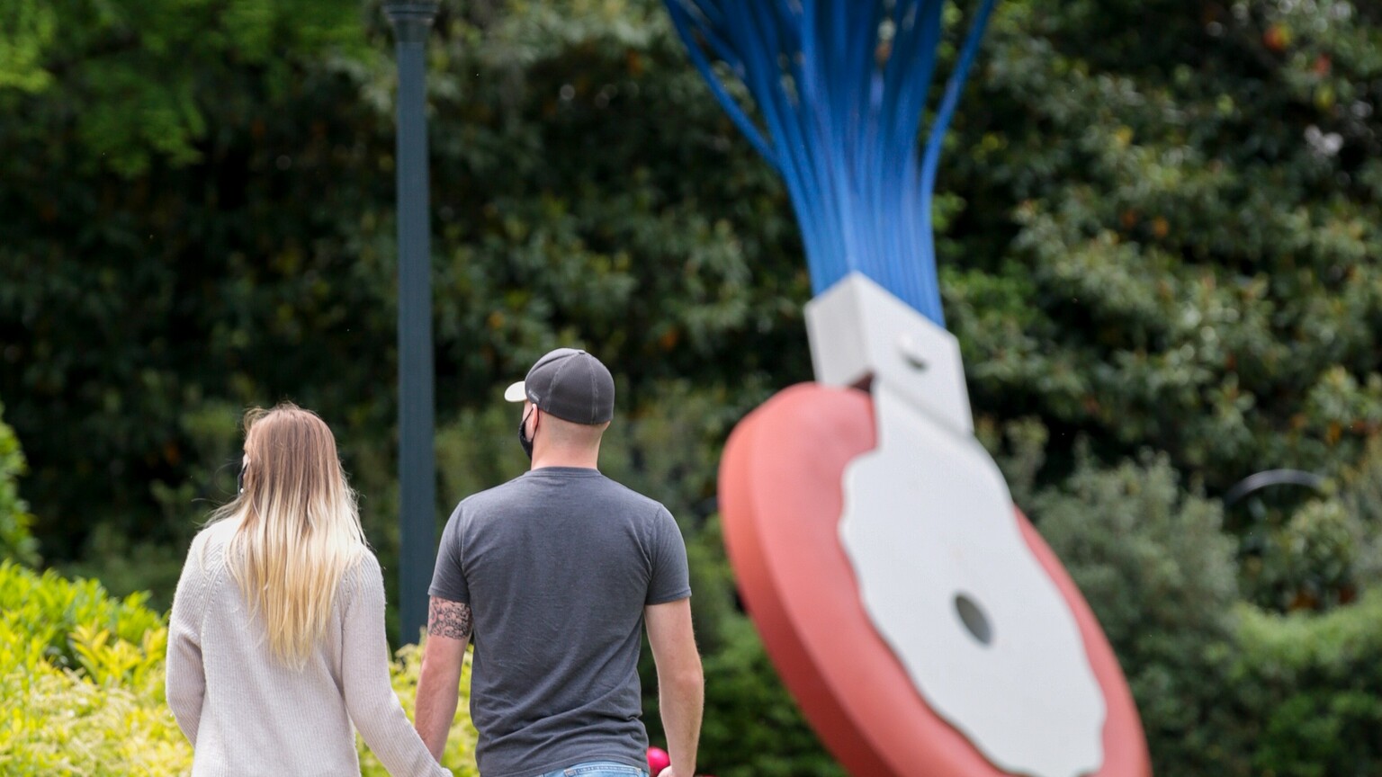 Visitors walking around and looking at art in the National Gallery's Sculpture Garden.