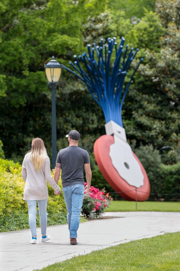 Visitors walking around and looking at art in the National Gallery's Sculpture Garden.