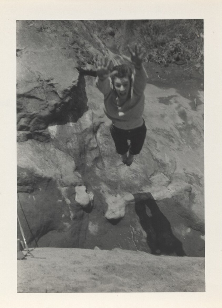 Untitled (Person in air above rocks)