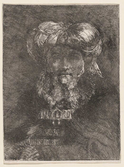 The image shows a person sitting with their body slightly angled. They have a mustache and a beard, and they are wearing a large turban. The person's attire is elaborate with detailed patterns or embroidery, especially near the chest area. The background is a textured, dark surface.