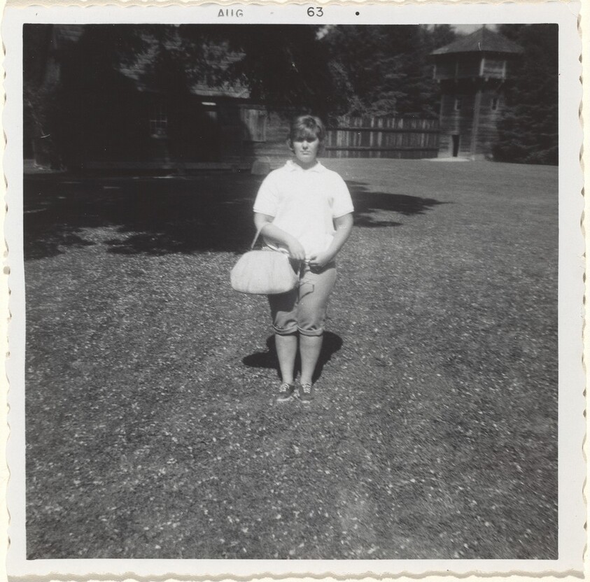 Untitled (Young woman with purse wearing dungarees)