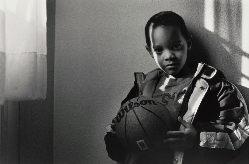 Darrius gets last minute instructions from Mom before going off to play in the back yard of his new Habitat for Humanity house, Arlington, Virginia