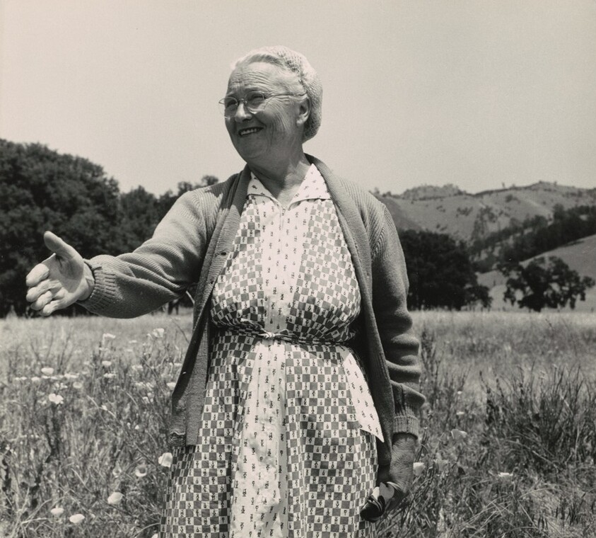 Woman from the Far West welcomes friends gathering on Memorial Day in the old cemetery of Berryessa Valley, California