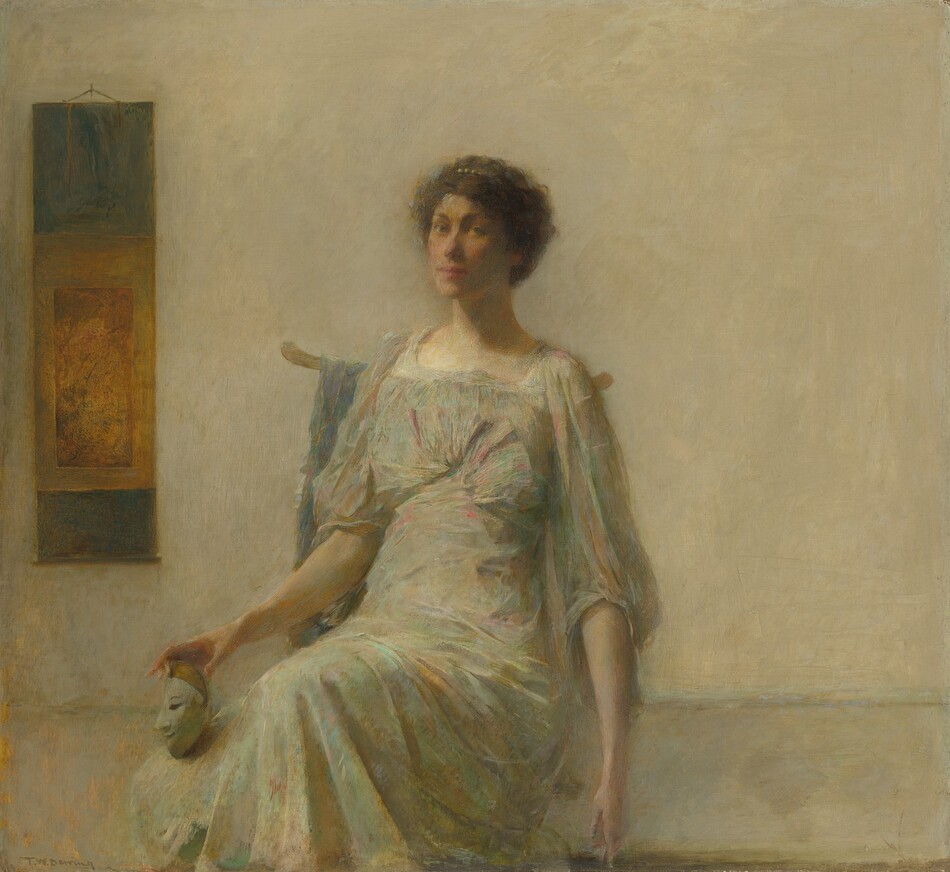 This painting shows a seated woman, her body turned slightly to the left and her head turned towards us. She is holding a small white mask in her right hand, balancing it on one of her knees. She has pale skin, high cheekbones, and pink lips in a neutral expression. She has short, dark, curly hair that is adorned with a pearl clip or headband. She is dressed in a light-colored gown with highlights of pink, green, and pale blue, with wide, flowing sleeves and fabric gathered at the bust. The background is a plain gray wall, with a hanging scroll or tapestry beside her on the left, containing shades of blue and gold.