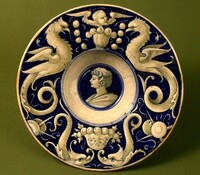 Broad-rimmed bowl with border of dolphins and "delphigriffs"; in the center, head of a young man, Probably Urbino district 16th Century, c. 1520/1530