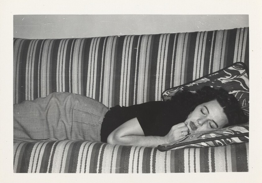 Untitled (Woman asleep on striped sofa)