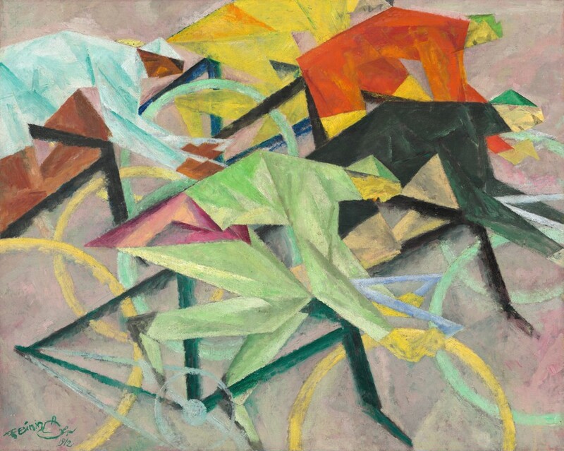 The bodies and bicycles of five stylized cyclists fill this nearly square painting so parts of some of their bodies and bicycles are cut by the edges of the canvas. Shown against a background of mottled shell pink and light gray, the riders are closely packed, their wheels and bodies overlapping, and they seem close to us as they race to our right in profile. All lean low over their handlebars. The faces of the three riders at the front of the pack have lemon-yellow skin. The person at the top of the composition, seeming the farthest away from us, has ivory-colored skin, and the person at the back, to our left, has brown skin. They all wear different colored clothing. The racer at the front wears all black, and the one closest to us celery green with fuchsia around the hips. The cyclists farthest from us wear rust orange or canary yellow. The racer with brown skin wears frosty blue. The frames of the bicycles are dark forest green or black, and the colors of the wheels are either yellow or turquoise. The people’s faces and bodies are abstracted into flat, hard-edges shapes. The angles formed by their torsos, arms, and legs are echoed by the angles of their bicycles’ dark metal frames.