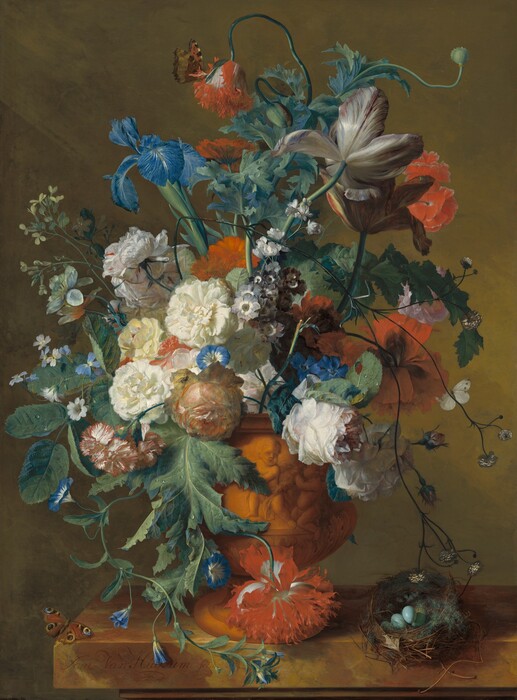 A tall arrangement of blue irises, cream-white carnations, violets, peonies, tulips, and other azure-blue, white, and scarlet-red flowers in a terracotta urn carved with child-like putti takes up most of the space of this vertical still life painting. The arrangement is warmly lit from the upper left and sits near a corner of a stone ledge veined in caramel brown and golden yellow. The ledge extends off the right edge of the painting. Most of the flowers face us but some face away or droop down. Leggy tulips in full bloom rise high in the bouquet. A cluster of white peonies veined lightly with pale pink are gathered near a crimson-edged white carnation and vivid blue forget-me-nots near the center, above the urn. The stems and blossoms of other flowers swirl and twist through the arrangement. A small brown and orange butterfly with black spots perches with wings slightly open on a scarlet-red poppy at the top center. Another butterfly sits with wings spread near the front corner of the ledge. Black circles surrounded by rings that blend from sapphire blue to butter yellow look like eyes at the tips of each of the four wings. A third butterfly with white wings is partly visible behind the petals of a ruby-red peony in the lower right. A small bird’s nest woven with twigs and green moss sits to our right of the urn, and is filled with four blue eggs. The background behind the arrangement is streaked with sable brown and mustard yellow. The signature of the artist is written in cursive on the face of the stone ledge near the corner, “Jan Van Huysum fecit.”