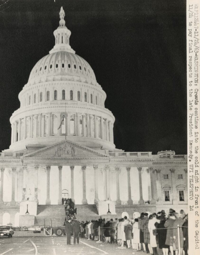 Title from caption on object: “Crowds Continue into the Cold Night in Front of the Capitol...”