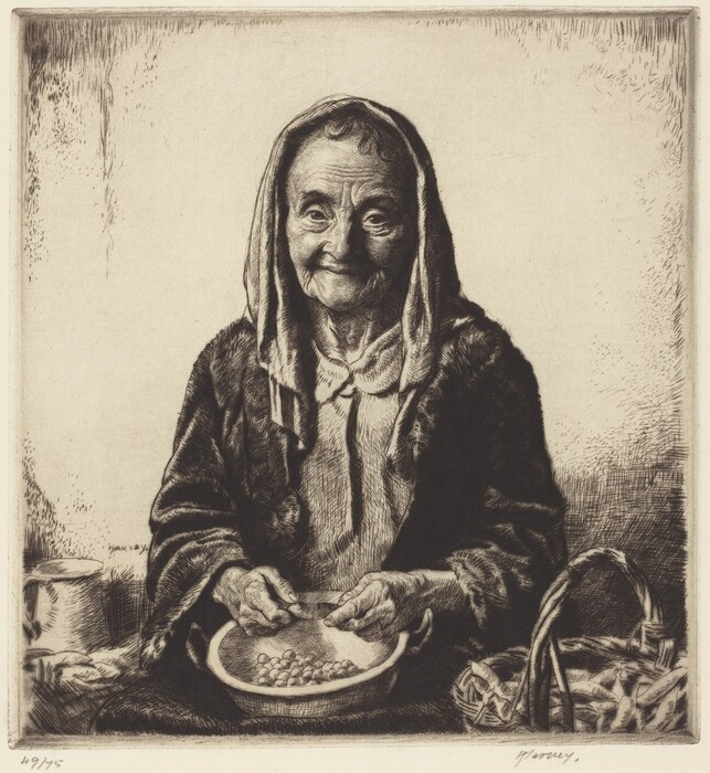 The image depicts an elderly woman shown from the waist up, sitting in a relaxed manner. She is positioned facing forward with her hands engaged in an activity involving a bowl of peas. Her facial features include pronounced wrinkles, a gentle smile, and eyes that appear attentive. Her hair is mostly covered by a headscarf, but it appears to be thin and parted at the front. The woman is dressed in a simple, textured garment. Beside her is a woven basket. The background is simple and plain.