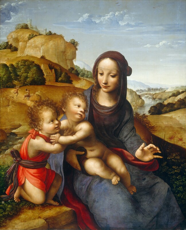 A woman and two small children, all with pale skin, sit on a rocky ledge in front of a hilly landscape in this vertical painting. The woman, to our right, holds one child on her lap and that child reaches to embrace the second child kneeling next to the woman, to our left. The woman, Mary, sits with her knees angled slightly to our right. She turns her face toward the child in her lap, to our left, but looks with shadowed eyes down in front of her. She has a long, delicate nose, rose-blushed cheeks, and her pale lips curl gently in a smile. Golden brown hair is parted down the middle over a high forehead, which is covered with a transparent veil that comes nearly to her faint eyebrows. A maroon-red hood covers her head and drapes across her shoulders under a slate-blue robe. Near one arm, the hem of the robe is turned back to reveal scarlet-red lining. She holds her left hand, to our right, slightly up with her palm facing us. Her other arm wraps around the nude child in her lap and rests against his hip. This child, Jesus, has a snub nose, rounded cheeks, and a pudgy body. He reaches to our left so his body is angled in that direction, but he turns his head back to look into the distance with pale brown eyes. To our left, the second child, Saint John, kneels and touches Jesus’s chest with one hand as he looks up and smiles at Mary. Saint John wears a ruby-red tunic tied at his right shoulder and a striped, wine-red sash around his waist is tied at his back. Both boys have reddish-blond curly hair, rosy cheeks, and are barefoot. Plants and flowers grow on the rocky ledge where they sit. To our left, beyond the trio, golden hills lead up to a ghostly gray castle on the highest peak. Closer to us but tiny in scale in the background, a person runs toward a man sitting on a rock and drinking out of a jug. A shallow waterfall emerges from the rocky base of the hill closest to us, just over John’s shoulder. The hills descend sharply to a river winding into the distance to our right, over Mary’s shoulder. Two white birds swim in the river near an arched bridge spanning the waterway. The river winds back to pale blue mountains along the horizon, which comes about two-thirds of the way up this painting. A few more people walk along paths and cross the bridge in the background. A few thin, white clouds float across the pale blue sky above.