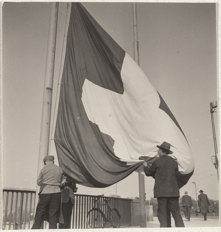 Men raising Swiss flag