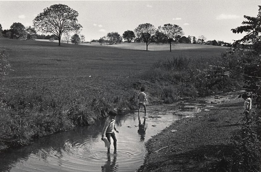Refugee boys playing in stream near the camp. Technically off limits, some straying was tolerated.