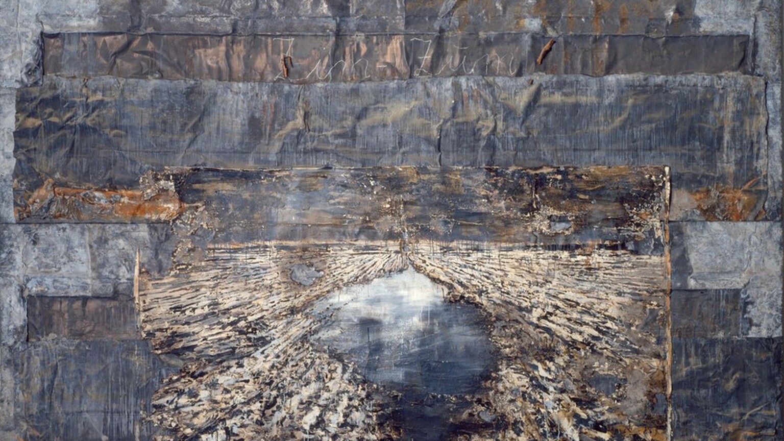 Horizontal bands of rumpled and wrinkled strips of lead are pieced together and overlap to create this horizontal, abstract work. The bands vary from smoke to charcoal gray, and there are some areas of burnt-orange rust. A smaller, ivory-white rectangle at the bottom center resembles a starburst created with textured, radiating bands of ivory and navy blue, surrounding a roughly teardrop-shaped hole that nearly spans the height of the smaller panel. The area within the teardrop is painted with smooth strokes of ice blue along the top, deepening to cobalt blue along the bottom. Tall letters in cursive white spelling out “Zim Zum” are written at the center of a band a quarter of the way down from the top edge of the composition.