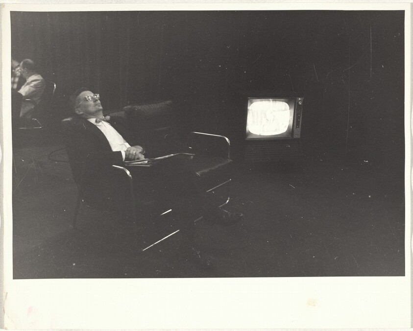 Man asleep before monitor, convention hall--Chicago