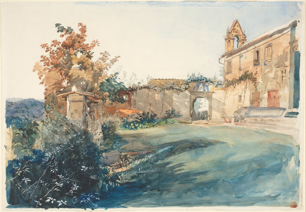 Sunlight pours across golden-tan colored buildings overgrown with verdant plants in this horizontal watercolor. The main two-story building is to our right on the far side of a grassy lawn. A vine creeps across its façade, and a triangular structure projects up over the front of the building, which faces away from us. A high wall extends to or left and then comes toward us. Copper-brown-leaved trees and dark green plants grow on both sides of the wall and over a shallowly peaked roof, which suggests a more substantial structure that has been lost in the growth. Slate-blue hills are glimpsed in the deep distance to the left of the wall.