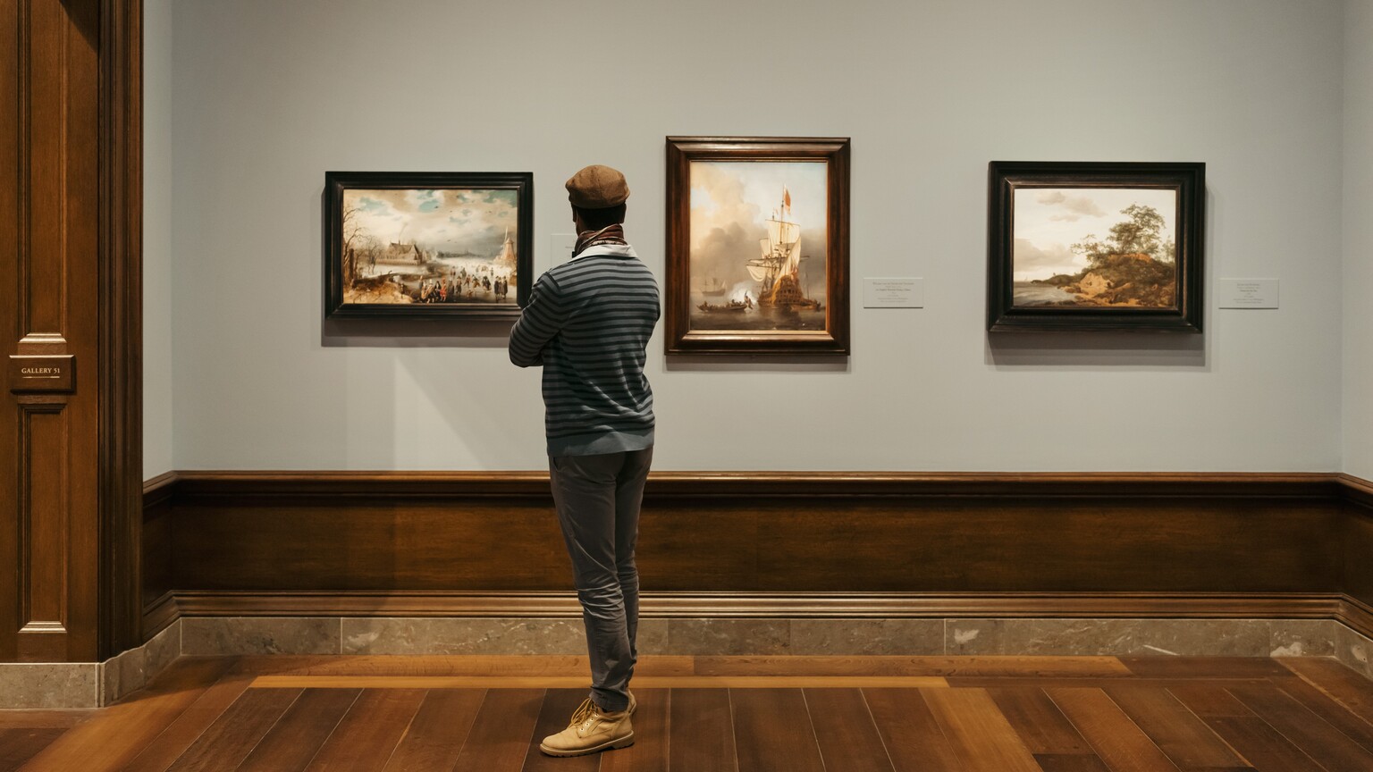 A visitor looking at a painting in the National Gallery of Art.