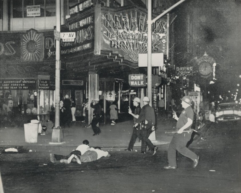 Title from caption on object: “Pistol-Wielding Police Clear Harlem Riot Area”