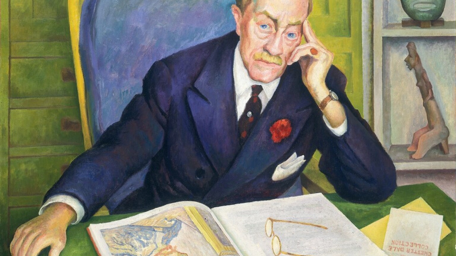 A pale-skinned man leans forward so his arms rest on the desk in front of us as he looks out with piercing blue eyes in this horizontal portrait painting. He rests his head in his left hand, to our right, with the first two fingers extended along his temple. His blond hair is carefully combed, and he has arched eyebrows, bags under his eyes, a wide nose, and a bristle mustache over his square, cleft chin. He wears a navy-blue suit jacket over a white button-down and dark tie. The jacket has a white pocket square and a red flower on one lapel. The man wears a red pinky ring on the hand by his face. The other arm is extended so that hand, which holds a cigarette, hangs beyond the edge of the tabletop. We look slightly down onto the desk where a pair of glasses rests on an open book, which shows a self portrait by Van Gogh. A pamphlet partially tucked under one corner of the book would read, in full, “FRENCH PAINTING from the CHESTER DALE COLLECTION.” The man sits in a high-backed chair with cushion mottled with amethyst purple and topaz blue. Close behind him, a shelf to our right holds a copper-green mask and a figurine. Pale green paneling and drawers fill the left two-thirds of the background. The painting is inscribed at the top left, “To my very dear friend Chester Dale Diego Rivera. August 1945.” Brushstrokes are visible in some areas, especially in the background and chair.
