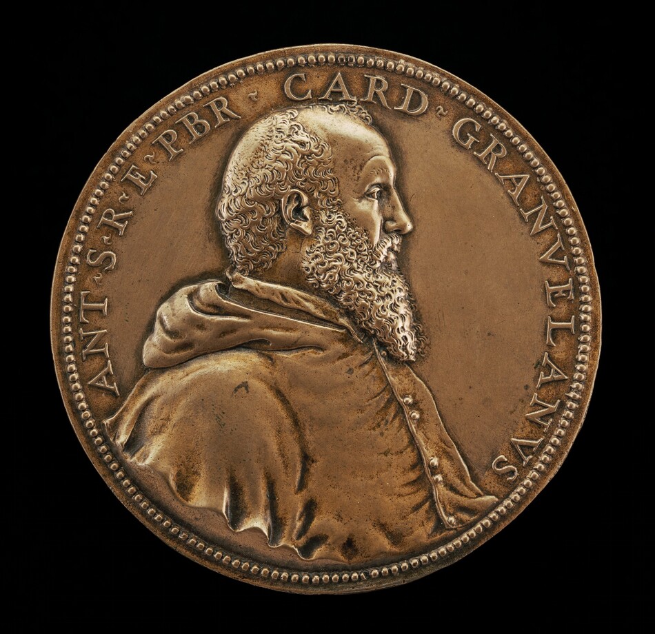 The image shows a medallion featuring a profile portrait of a man identified as "CARD GRANVELAN" referring to Cardinal Granvelle. The man faces right with curly hair and a full beard, wearing a garment with a buttoned collar and a cloak. The bronze-colored medallion has a raised border and an inscription around the portrait. The sculpture captures fine details of the man's facial features and clothing textures.