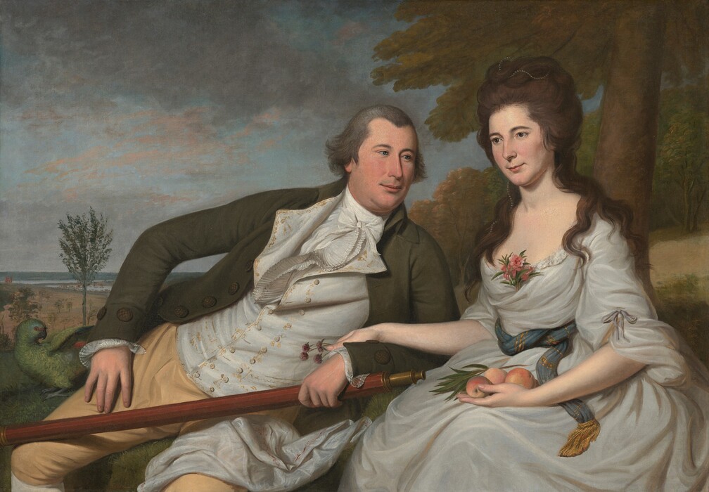 Shown from the knees up, a light-skinned man and woman are seated side-by-side on grassy rise in a landscape in this horizontal portrait painting. To our left, the man leans heavily toward the woman to our right, propped on one elbow near her hip. She sits upright, resting one hand over his forearm and wrist. The clean-shaven man looks at her with blue eyes under gray, arched brows. He has a straight nose, round cheeks, a hint of a double chin, and his pale pink lips are closed in a slight smile. He wears a forest-green coat, a white waistcoat embroidered with golden yellow, a white shirt and ruffled tie, and buff-colored breaches. His right hand, to our left, is propped loosely against his hip. Next to that hand, a green parrot stands with its wings lifted as it turns its head back over its body. The man’s other hand, near the woman, holds a long, wooden telescope. The woman looks off into the distance to our left with gray eyes. She has smooth cheeks, a delicate nose, and her pink lips also curl in a faint smile. A strand of pearls weaves through the brown hair loosely piled on her head and through the thick curls that fall over her shoulders. Her white dress is loosely draped around her body. An ocean-blue sash with gold stripes and fringe wraps around her waist, and a sprig of pink flowers is tucked into a fold at her neckline. She holds at least three peaches and a stem of leaves in her lap, and a spray of purple clover blossoms in her other hand, which rests lightly over the man’s forearm. A swath of white fabric, perhaps from her skirt, wraps up and over the man’s thigh, closer to her. Behind the woman, a tree grows on a low hill along the right edge of the canvas and off the top. The landscape opens into an expansive vista to our left with spindly trees growing in a low meadow that leads back to a body of water in the deep distance. Minuscule in scale, tiny boats and buildings line the water’s edge near the horizon. A few thin, silvery gray and petal-pink clouds skim across the pale blue sky.