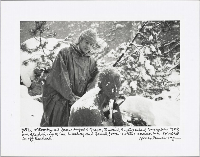 Peter Orlovsky at James Joyce’s grave, Zurich Switzerland December 1980, we climbed up to the cemetery and found Joyce’s statue snow covered, brushed it off his head.