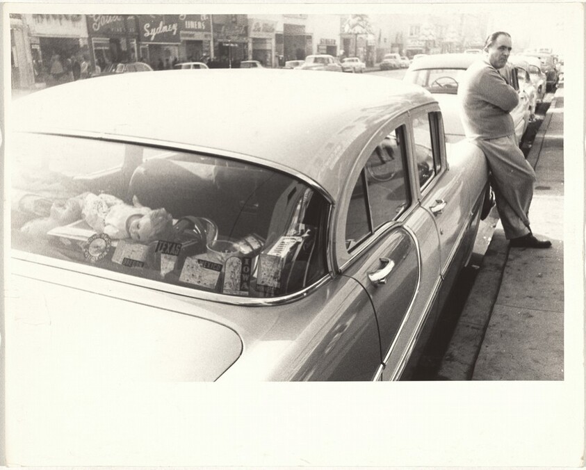 Man leaning against automobile--Hollywood Boulevard