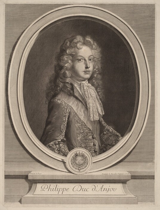 The image shows a portrait of a person's upper body, with the focus on their head and torso. The person is looking slightly to the right but appears to be gazing at the viewer. They have long, curly hair reaching their shoulders, delicate facial features, and a soft expression with slightly parted lips. The person is wearing luxurious clothing, including an embroidered jacket and a lace-trimmed cravat, indicating high status. There are no visible jewelry or objects in their hands. The portrait is within an oval frame, with a neutral background. At the bottom of the image is an inscription that reads "Philippe Duc d'Anjou" along with decorative elements.