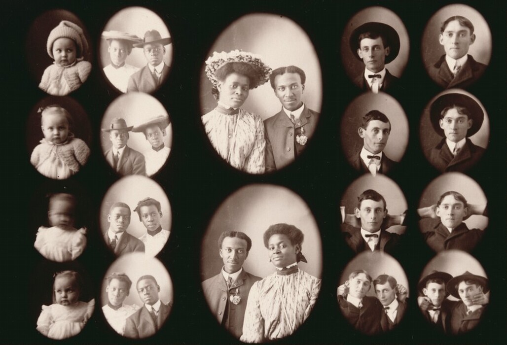 The image is a collage of vintage portrait photographs. Each oval frame displays a different individual or group from the chest up. In the central frame, a woman and a man stand closely together. The woman has neat, pulled-back hair adorned with a large hat decorated with flowers, and she is wearing a high-collared, patterned dress. The man beside her has short, well-groomed hair and wears a suit with a flower boutonniere. Surrounding these central figures are smaller portraits of various individuals including young children and adult men. The children are shown wearing knitted clothing, and one of the babies is in a cozy bonnet. The men around the central photo sport bow ties and hats in different styles. Some are looking directly at the camera while others strike relaxed poses. The background is consistent with a neutral studio setting, likely a backdrop used for such portrait photography.
