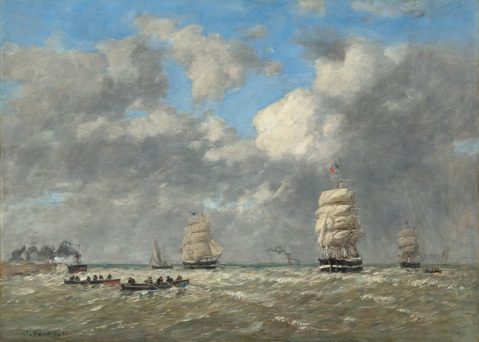 We look across a channel of choppy water at three masted ships, a sailboat, at least one steamer, and three rowboats in this horizontal seascape painting. The white peaks and waves are painted with pearlescent shades of white, gold, ice blue, and the faintest pink tinge. The steamer belches gray smoke along a coastline in the distance to the left. The sailboat is farther back. Two of the three masted ships edge closer to us to the right of the sailboat. The ship is first almost halfway across the canvas from the left edge, and the second, which flies a flag vertically striped with blue, white, and red, is about two-thirds of the way across. The third masted ship is much farther away near the right edge of the composition. Two of the long rowboats are near the bottom left corner of the painting and the third is far out by the third ship. The horizon comes about a quarter of the way up the painting. Puffy gray clouds pile up on the horizon and are edged in white where they face open blue sky along the top edge. Cloud cover is streaked around the most distant ship, suggesting that a storm has begun. The scene is loosely painted with visible brushstrokes throughout. The artist signed and dated the painting in the lower left corner, “E. Boudin. 83” and labeled the location to the right, “Le Havre.”