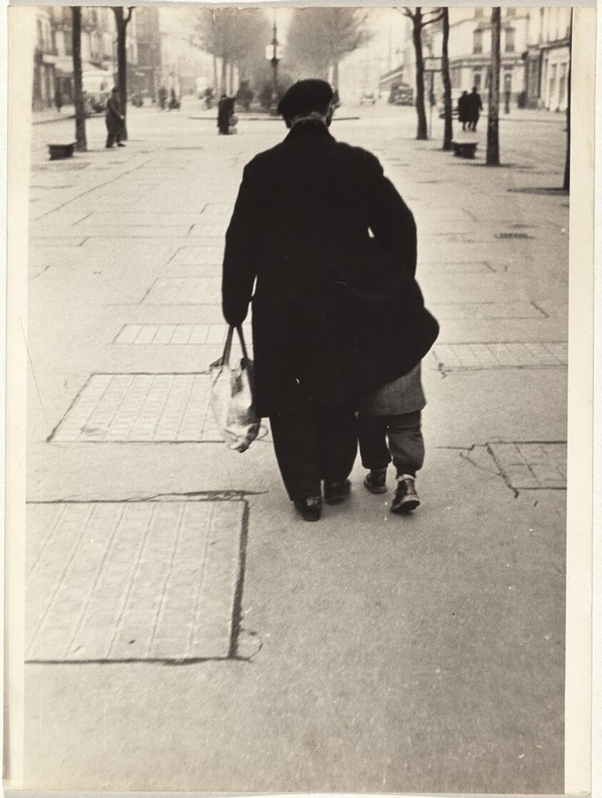 Man with child on street, Paris