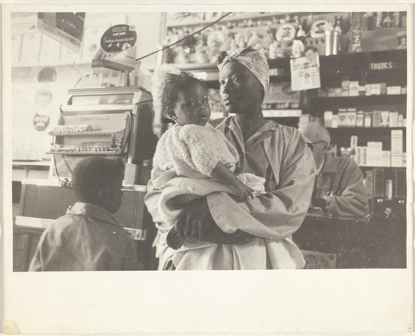 Mother and two children at store counter--Port Gibson, Mississippi