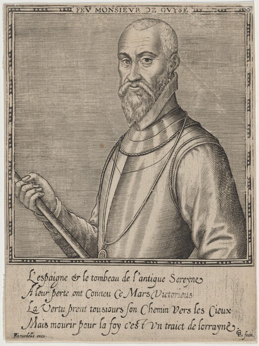 The image shows a man depicted from the waist up, facing slightly to the right while looking directly at the viewer. His head is turned to the side with a serious expression, and he has a prominent, orderly beard along with short hair that is closely cropped around the sides. The man is dressed in armor, which includes a detailed cuirass that covers his torso. He is holding a rod or baton in his left hand, with his fingers loosely wrapped around it. A chain is draped over his shoulder, and an earring can be seen in his left ear. In the background, there is an engraved border with some text above and below the portrait. The area surrounding the man is plain.
