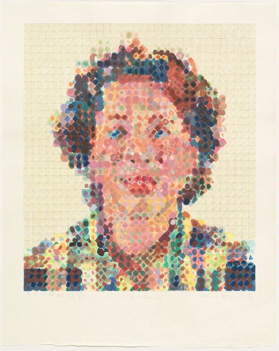 The image depicts a head and shoulders portrait of a person created in a pointillist style, composed of multicolored dots. The person is facing forward. The facial features are obscured due to the dot pattern. The hair is depicted in dark colors with hints of blue and brown. The clothing is a patterned top with a mix of colors including greens, reds, and yellows. The background is a light-colored grid pattern. There are no visible jewelry or objects. The portrait is contained within the grid pattern against a plain, light-colored background.