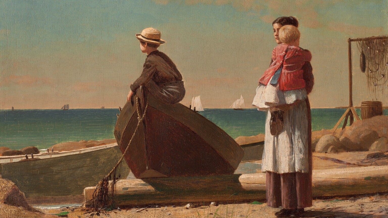 A woman holding a baby stands near a young boy who perches in the tipped-up end of a rowboat that has been pulled onto a sandy beach in this horizontal painting. All the people have light skin. The turquoise and aquamarine-blue ocean beyond meets the pale blue sky at the horizon line, about halfway up the composition. To our left of center, one end of the wooden rowboat has been propped on what might be a fallen piling on the sandy, rocky beach. The boy sitting in the bow faces our left almost in profile, and wears a round, brimmed straw hat over brown hair, a brown, long-sleeved shirt, and charcoal-gray pants. His face turns away from us so we only see his cheek and the curve of his ear. To our right, the woman’s dark hair is pulled up and she wears a white apron over a long brown skirt. She stands angled to our right and looks over the shoulder of the blond baby she holds up against her chest. The child is dressed in a white skirt, blue sash, a red jacket, and black shoes. The beach around the people is strewn with another rowboat, large boulders, a wooden barrel, and fishing nets hung over a tall frame to dry. A few tufts of scrubby grass grow in the sand around the woman’s feet. The white sails of several ships line the horizon in the deep distance. Thin, pale peach clouds float across an ice-blue sky. The artist signed and dated the work in dark paint in the lower left corner: “WINSLOW HOMER 1873.”