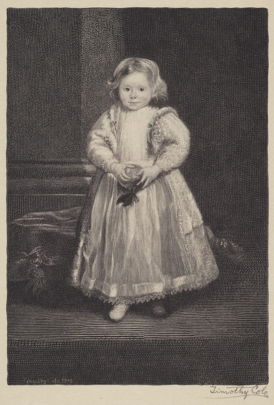 The image shows a young child standing upright, facing forward with their hands clasped in front of them. The child has softly curled hair, a small mouth, and inquisitive eyes. They are dressed in ornate clothing, wearing a long gown with textured details and a high neckline. The child holds a flower delicately. The background is a dark, intricately patterned surface, suggesting an indoor setting.