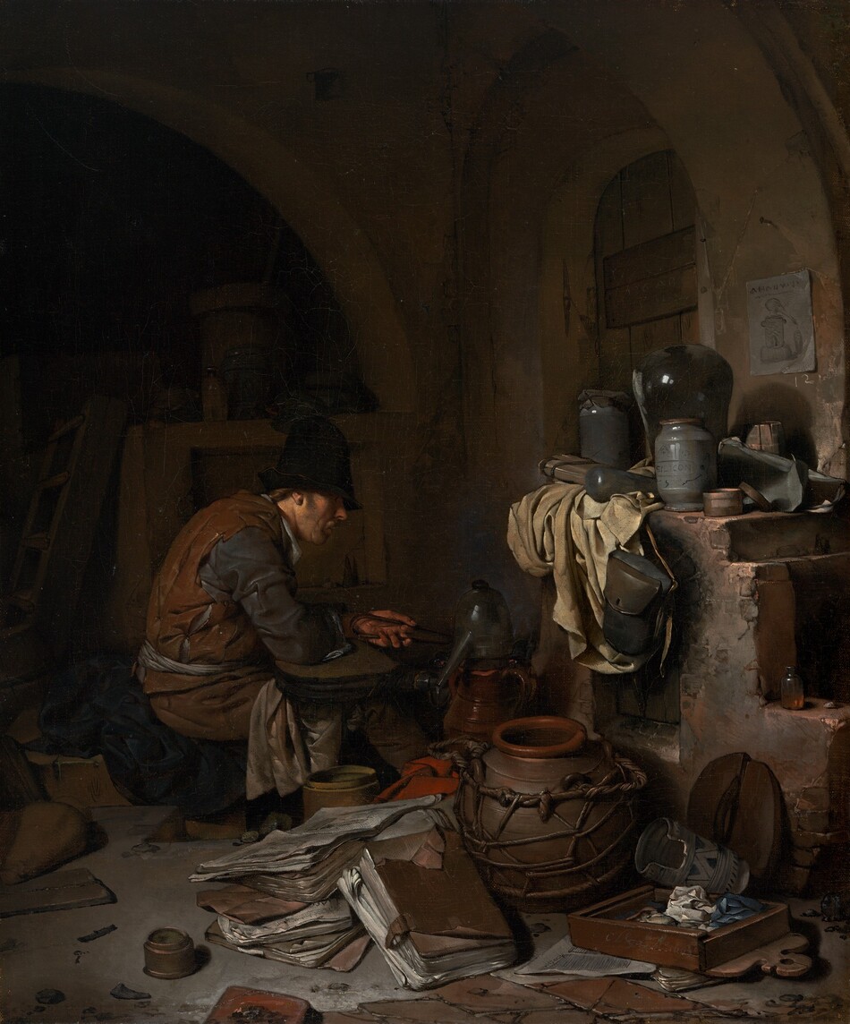 A light-skinned man sitting near an oven is surrounded by papers and vessels, all within a shadowy room in this vertical painting. The scene is dominated by chocolate and clay brown, black, slate blue, and shades of gray. The man sits facing our right in profile near the center of the painting. He wears a tall black cap that shadows his eyes and a rust-brown sleeveless garment like a vest over dark, steel-gray, long sleeves. Cream-white fabric tied around his waist could be an apron, and more white fabric drapes over his knees. Brown hair is visible behind his ear, he has a mustache, and his lips are parted as he looks down toward the instruments in front of him. He is hunched over, the elbow closer to us on what might be a flattened bellows, and he holds tongs in his left hand. The vessel in front of him could be made from pewter or glass, and it has a high, curved top and a long spout angled downward. Other pots and a red cloth are jumbled with large, leather-covered folios like thick folders of papers on the floor close to us. More papers, pots, and containers sit on a wide ledge over the open fireplace or oven to our right. A piece of parchment-white cloth hangs down the front of the oven next to a leather knapsack that hangs from the mantle. The top zone of the painting is deep in shadow but there seems to be an arched window or door covered with a wooden shutter to our right, behind the oven. A piece of paper affixed to the wall near the opening shows a vessel like the long-spouted vessel in front of the man. A shallow wooden box near the lower right corner seems to be filled with crumpled paper or cloth. The artist signed and dated the front face of the box with light letters: “C. Bega Ao. 1663.”