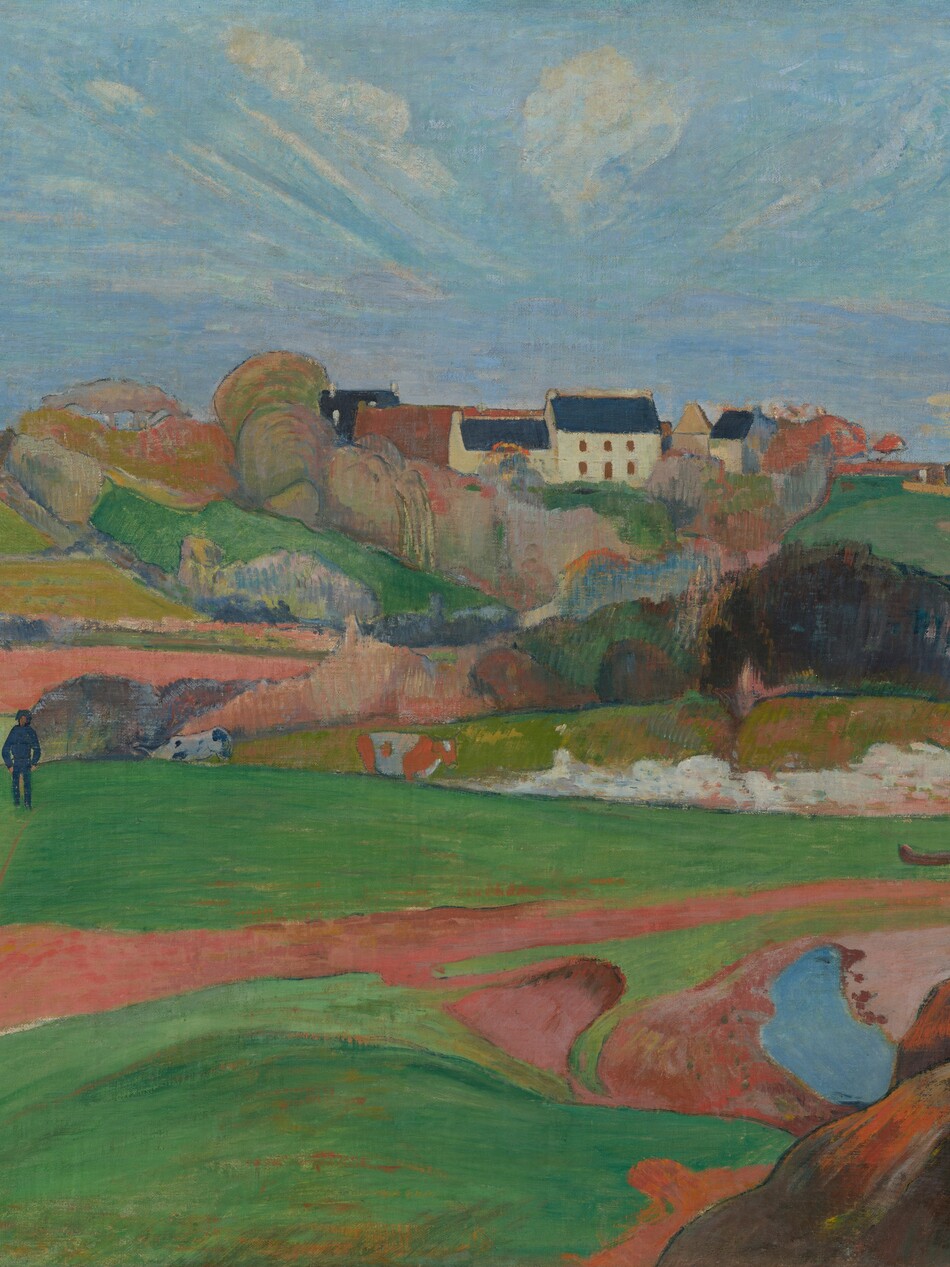 We look across rolling, bright green pastures and honey-brown farmland to a cluster of buildings nestled beyond a copse of trees, along the horizon in this horizontal, stylized landscape painting. The scene is painted with mostly flat areas of color. Closest to us, low, vibrant green pastures are bisected by a narrow, gingerbread-brown path. The path meanders from the lower left corner of the composition to a metal gate, near the right edge of the painting. A short distance from us to our left, a man wearing navy-blue pants, shirt, and hat walks along the top of a hill, hands in pockets. Two black and white cows and one brown and white cow graze nearby. In the distance, the copse of trees is painted with pockets of pumpkin orange, lavender purple, sky blue, and spring and muted sage green. Beyond the trees, a white, square, two-story house with a spruce-blue roof sits within the grouping of buildings. Another white building with a blue roof stands a bit to our right. Wisps of white clouds dot a vivid blue sky, which is tinted with pale pink and lilac purple near the horizon. The artist signed and dated the work in harvest yellow against a mound of dark brown rocks in the lower right corner: “P. Gauguin 90.”