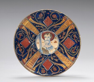 Small flat plate with border of cornucopias, scrollwork, and lozenges in four sections; in the center, a bust of Saint Paul with raised sword